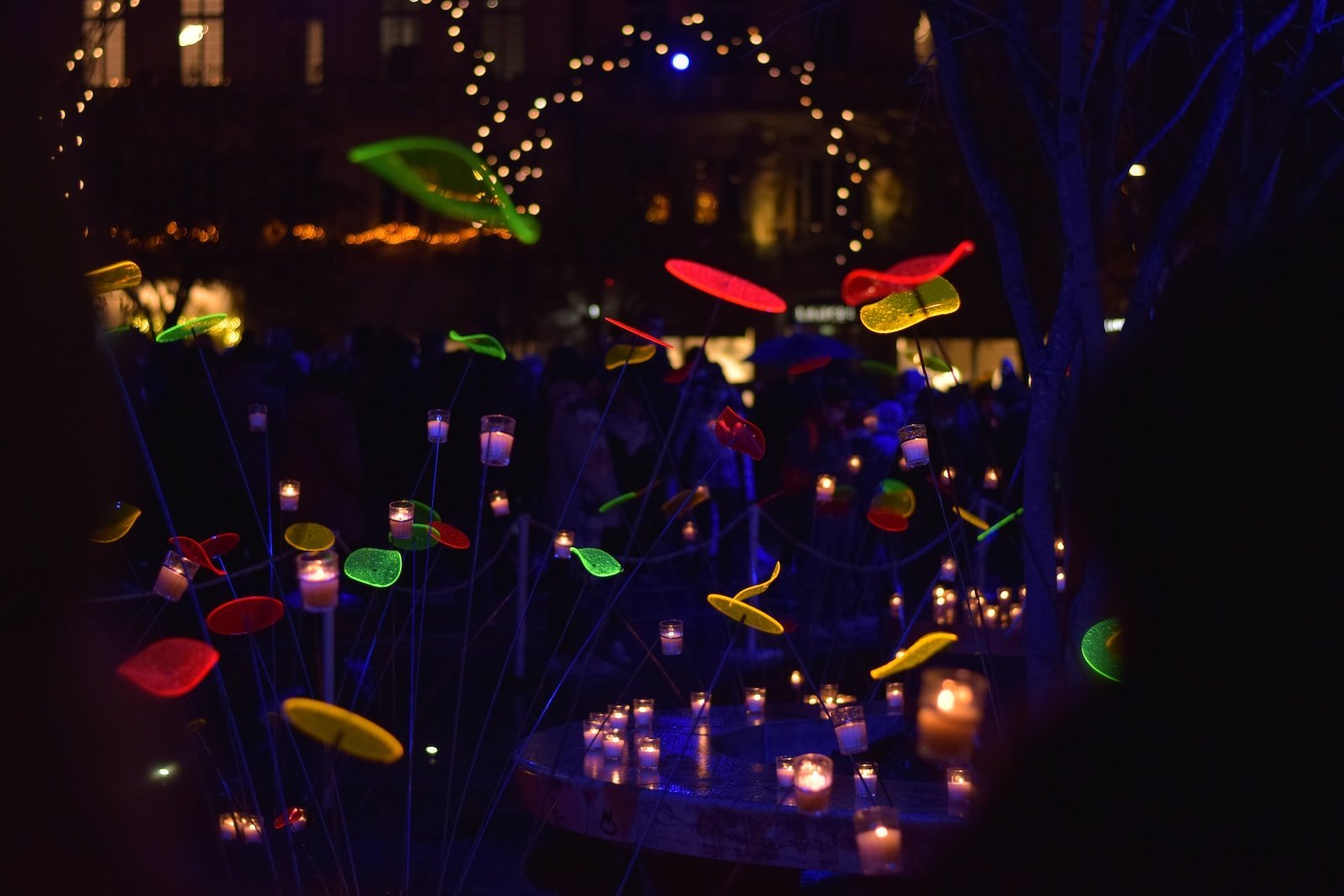 a group of people standing around a display of lights